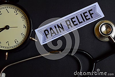 Pain Relief on the paper with Healthcare Concept Inspiration. alarm clock, Black stethoscope. Stock Photo