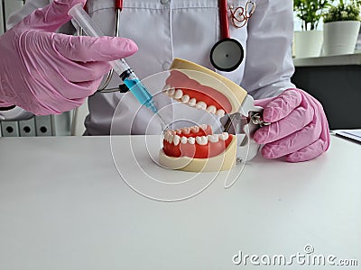 Pain relieving tooth injections. Injection of anesthetic into gum and anesthesia for tooth treatment Stock Photo