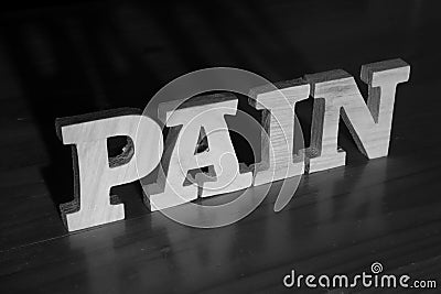 Pain, text words typography written with wooden letter on black background, life and business negativity Stock Photo