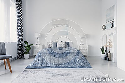 Paining above big comfortable bed in luxury new york style bedroom, real photo Stock Photo