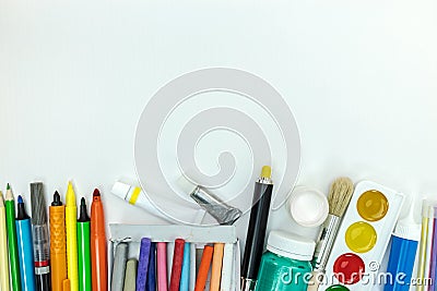 Variety of colorful pencils, paints, markers on white background Stock Photo