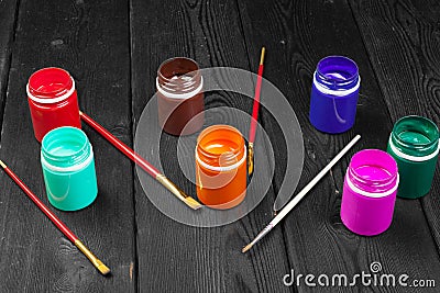Paint bottles on rustic wooden background. creative photo Stock Photo