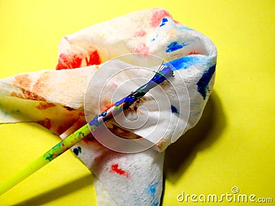 Paint brush and cloth dirty after cleaning the brush. Concept of artist at work, kids early development, art therapy Stock Photo