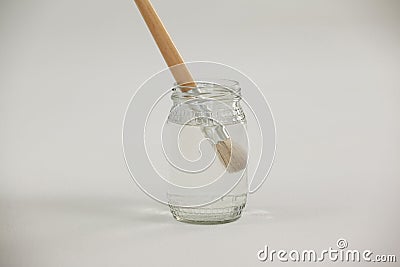 Paint brush in a jar filled with water Stock Photo