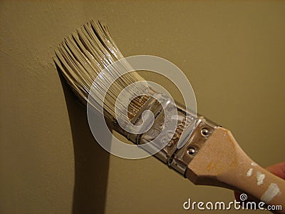 Paint brush painting a wall Stock Photo