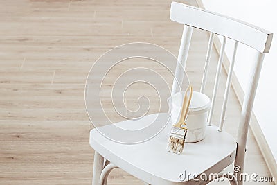 Paint and brush for repainting an old chair. Upcycling concept Stock Photo