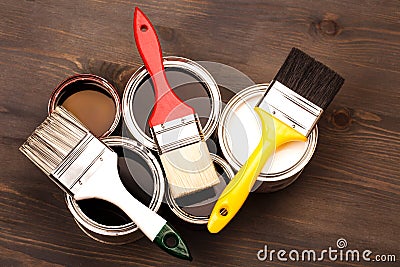 Paint brushes on five cans Stock Photo