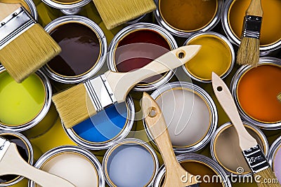 Paint can with a paintbrush, yellow background Stock Photo