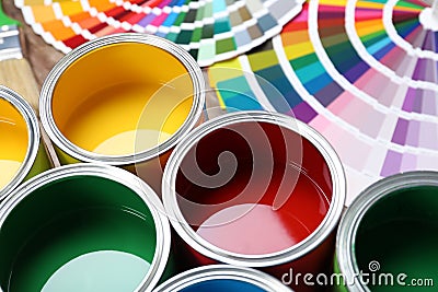 Paint cans and color palette samples on table Editorial Stock Photo