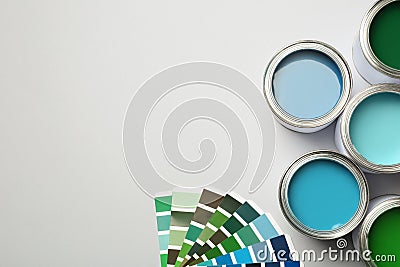 Paint cans and color palette on white background, top view. Stock Photo