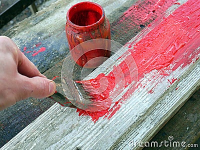 Old brushes in the paint process of painting an old board Stock Photo