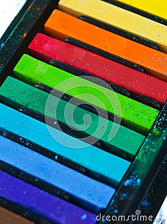 Paint, pastel and color chalk in studio for rainbow or vibrant creativity, texture and pigments for fine or visual arts Stock Photo