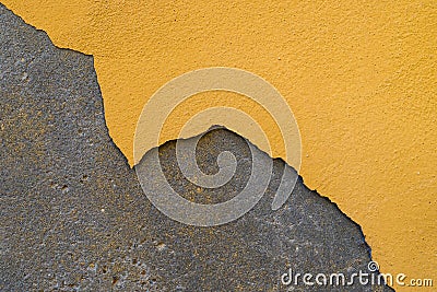 Paint peeling off the plastered wall. The building needs repair. Stock Photo