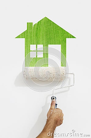 paint roller hand with green house symbol painting on wall isolated on white Stock Photo
