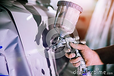 Paint sprayer in hand Stock Photo