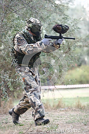 Paintball player aiming the gun Stock Photo
