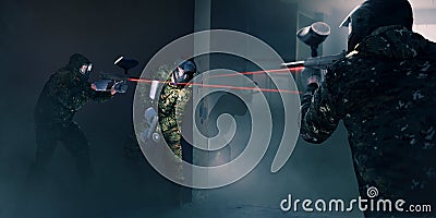 Paintball team in battle, guns with a laser sight Stock Photo