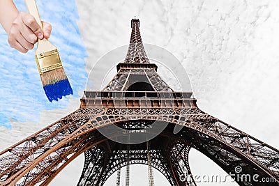 Paintbrush paints blue sky over Eiffel tower Stock Photo