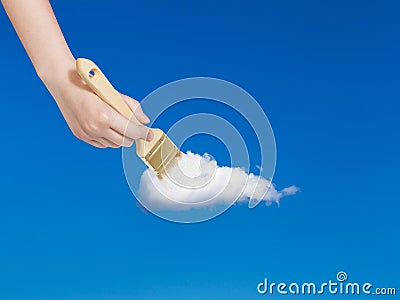 Paintbrush paints solitary white cloud in blue sky Stock Photo