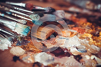 Paintbrushes closeup, palette and multicolor paint stains Stock Photo