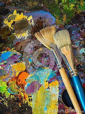 Paintbrushes on the palette for mixing oil paints Stock Photo