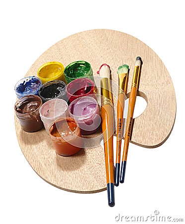 Paintbrushes on wooden palette. Stock Photo