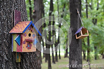 Painted birdhouse in the park Stock Photo