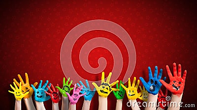 Painted children hands with smiley in front of christmas background Stock Photo