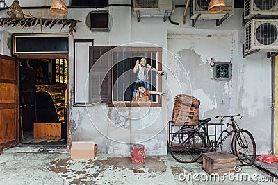 Painted Children Try to Steal Food from Food Bike from The front of Restaurant of George Town. Penang, Malaysia Editorial Stock Photo