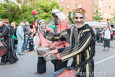 Painted and disguised musicians during the celebration of the feast of Saint George and the dragon. Editorial Stock Photo