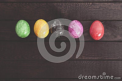 Painted Easter eggs on dark wooden table. Toned. Stock Photo