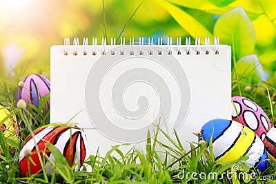 painted eggs with a happy easter text notepad on Stock Photo