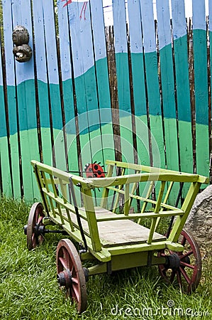 Painted fence with Hay-waggon Stock Photo