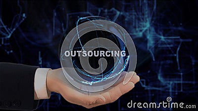 Painted hand shows concept hologram Outsourcing on his hand Stock Photo