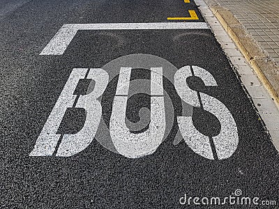 Painted inscription BUS on the road surface. Stock Photo