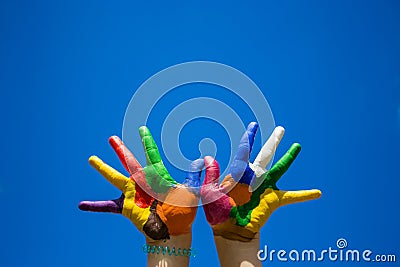 Painted kids hands on blue sky backgrobnd Stock Photo