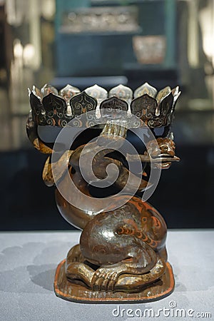 painted lacquer flower-shaped tray supported by a dragon and a snake Editorial Stock Photo