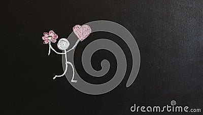Painted man holding a pink heart and a flower. Black background. Gift concept. Stock Photo