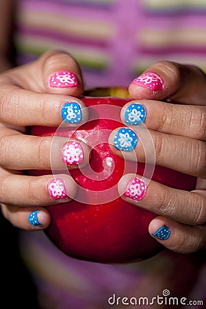 Painted nails and an apple Stock Photo