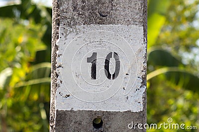 Painted number ten (10) on a concrete column Stock Photo