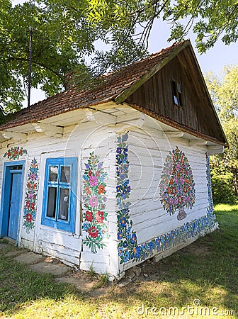 Painted old wooden cottage decorated with a hand painted colorful flowers, Zalipie, Poland Editorial Stock Photo