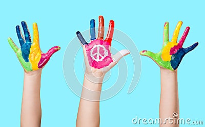 Painted peace sign in girl's hand against war. Stock Photo