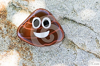 Painted rock of poo emoji Stock Photo