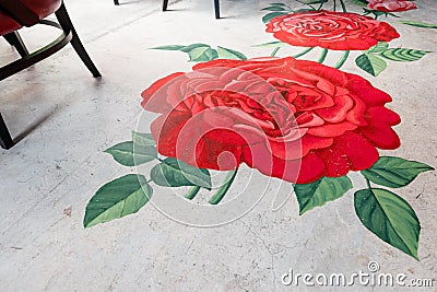 Painted roses with leaves on concrete floor. Interior restaurant decoration Editorial Stock Photo