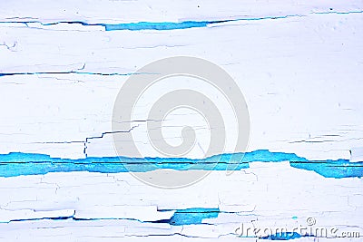 Painted rough wooden background, old wall with cracked paint white on blue backdrop. Stock Photo