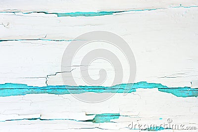 Painted rough wooden background, old wall with cracked paint white on turquoise backdrop. Stock Photo