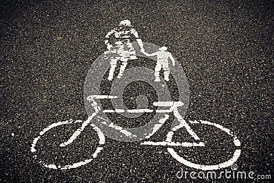 Painted sign on asphalt, bicycle woman with child Stock Photo