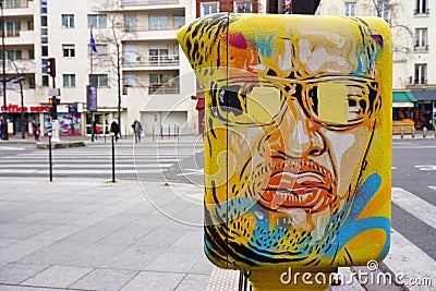 Painted yellow mailbox covered with street art by French graffiti muralist C215 in Paris Editorial Stock Photo