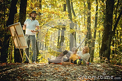 Painter artist with family relaxing in forest. Painting in nature. Start new picture. Capture moment. Beauty of nature Stock Photo