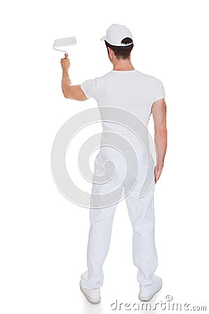 Painter holding paint roller Stock Photo